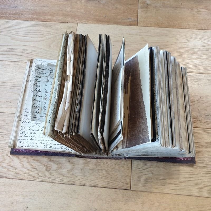 An vintage book containing bound old letters